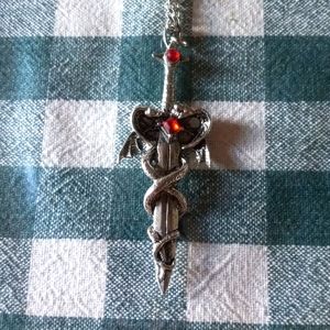 Metal sword and winged serpent necklace